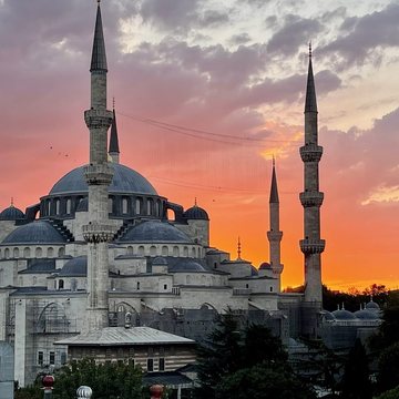 The Blue Mosque silhouetted against an orange sunset, Istanbul